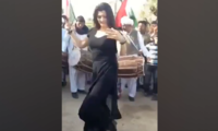 Video surfaces of political workers showering cash on dancer