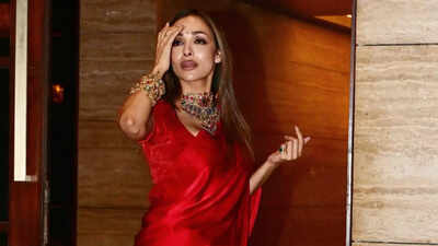 Malaika Arora looks like 'fire not flower' in a fiery red satin saree at an engagement party