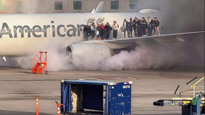 Passengers evacuate onto wing as American Airlines plane catches fire in Denver