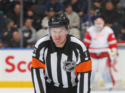 NHL referee Kelly Sutherland helps Steven Lorentz score a winning goal for the Toronto Maple Leafs