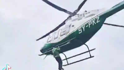 What? Man hangs from helicopter after being denied a ride-- Watch viral video