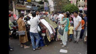 Hawkers’ display counters: Bikes, car bonnets, lamp posts, cables, railings