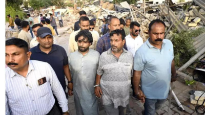 Cops take father-son duo to Chandola lake in crackdown on illegal Bangladeshi settlement
