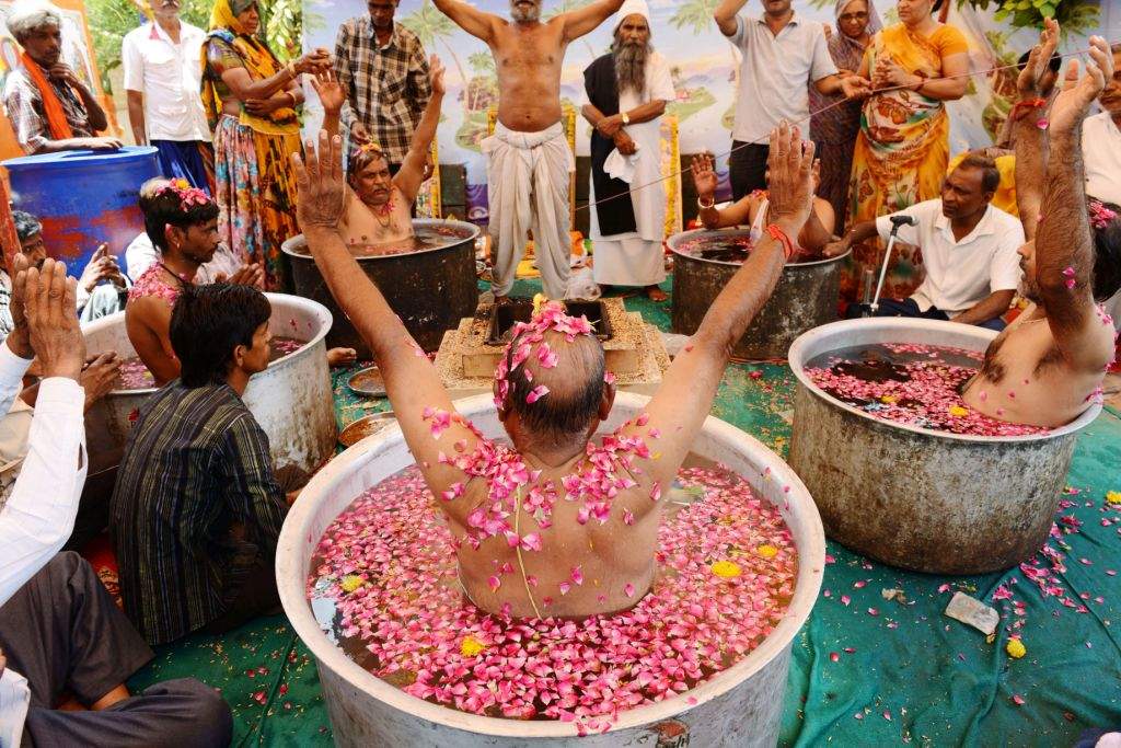 Men perform rituals to appease the rain God on the outskirts of Ahmedabad, India. (AFP PHOTO / Sam PANTHAKY)