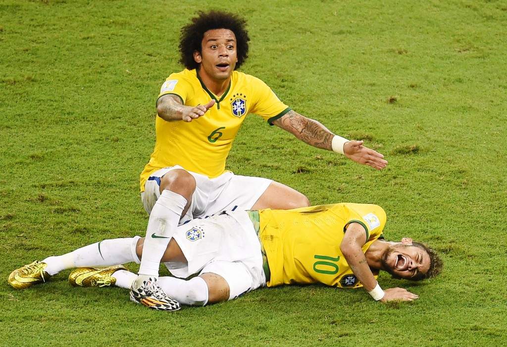 Defender Marcelo shouts for help after Brazil's forward Neymar was injured during the quarter-final football match between Brazil and Colombia during the 2014 FIFA World Cup. (AFP PHOTO / ODD ANDERSEN)