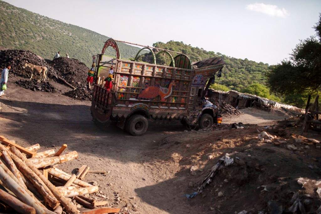 A truck drives past a coal field in Choa Saidan Shah, Punjab province