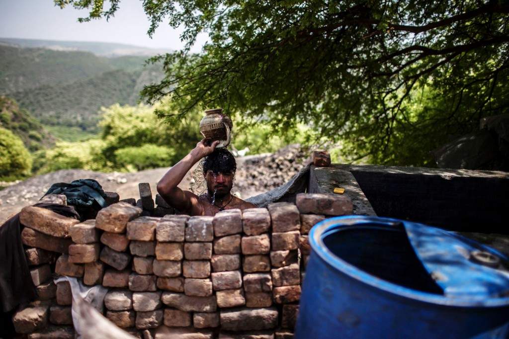 A miner washes after finishing his shift at a coal mine in Choa Saidan Shah, Punjab province