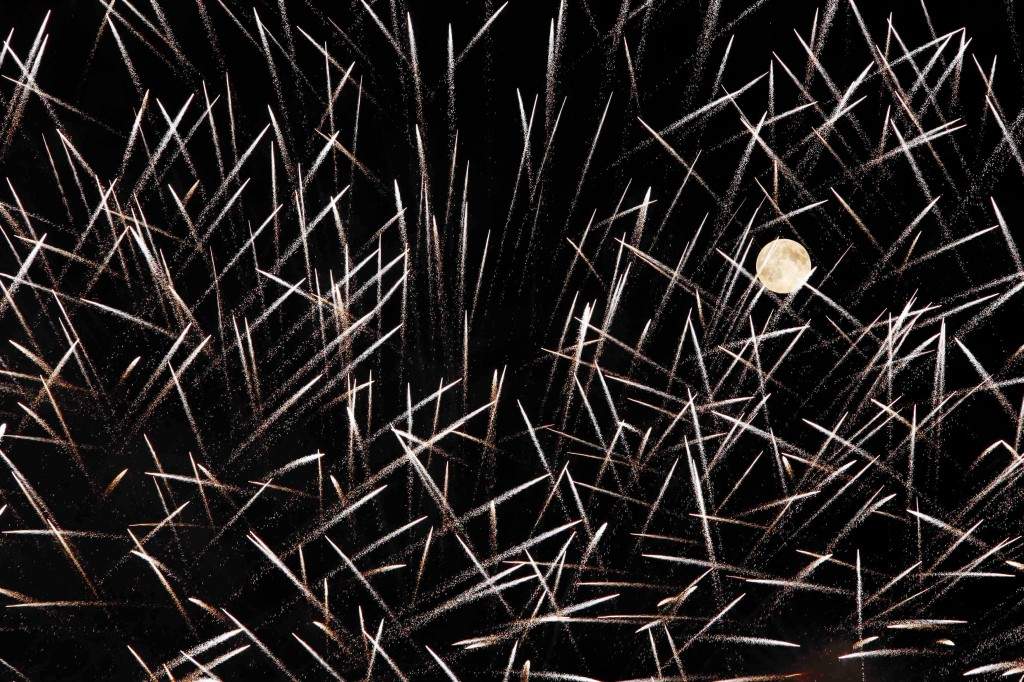Fireworks streak past in front of the supermoon outside the town of Mosta. (REUTERS/Darrin Zammit Lupi)
