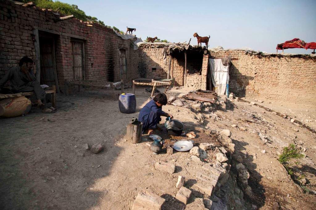 Samiullah washes dishes at a coal mine in Choa Saidan Shah, Punjab province
