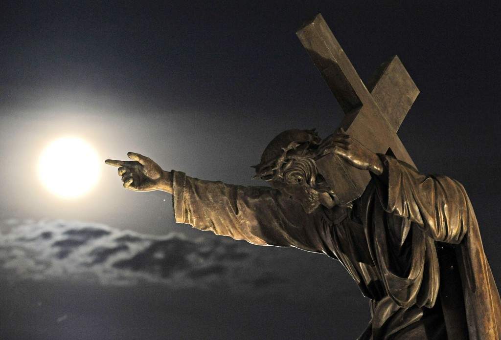 A supermoon rises above a Jesus Christ statue in front of the Holy Cross church in Warsaw, Poland. (AP Photo/Alik Keplicz)