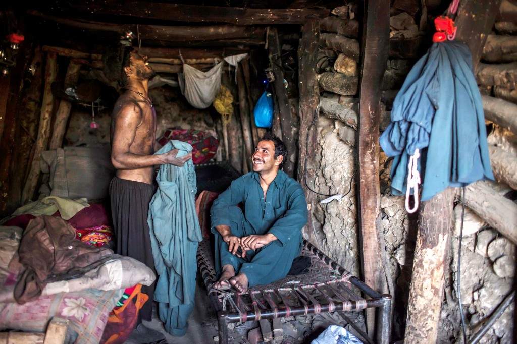 Miners rest in their rooms at the end of the day at a coal field in Choa Saidan Shah, Punjab province