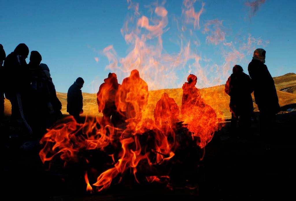 People burn offerings to 'Pachamama,' or 'Mother Earth,' and ask for good fortune on La Cumbre, a mountain that is considered sacred ground, on the outskirts of La Paz, Bolivia. (AP Photo/Juan Karita)