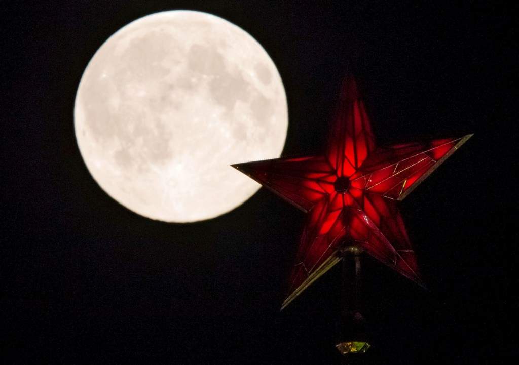 The supermoon rises over the stars of Moscow's Kremlin towers. (REUTERS/Maxim Shemetov)