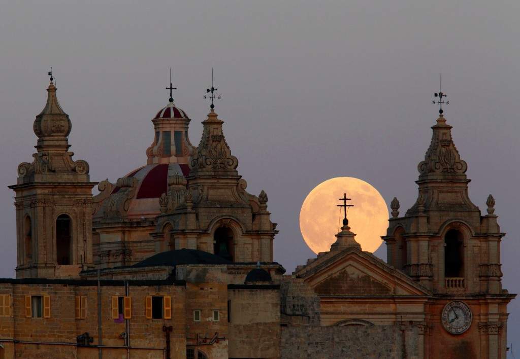 The supermoon rises behind the cathedral in Mdina, Malta's ancient capital city, in the centre of the island. (REUTERS/Darrin Zammit Lupi) 