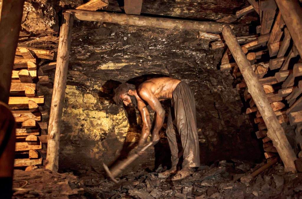 Zamurud Khan breaks coal at a mine in Choa Saidan Shah, Punjab province