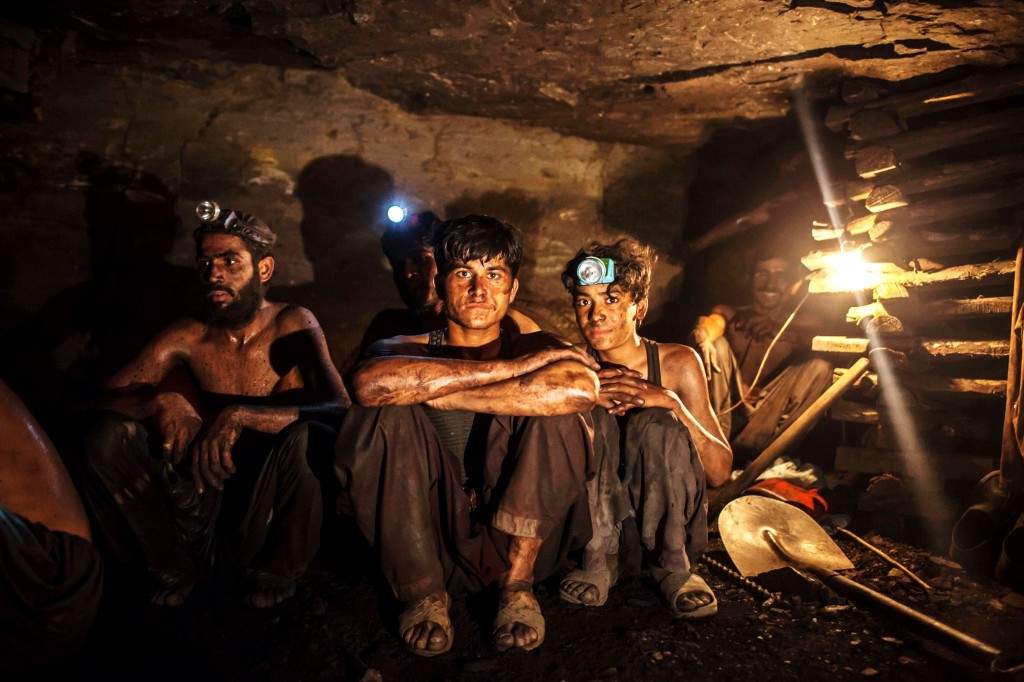 Miners pose for a photograph at the coal face inside a mine in Choa Saidan Shah, Punjab province