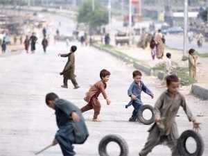 Wheels of change? Children play at Pakistan's protest sites.