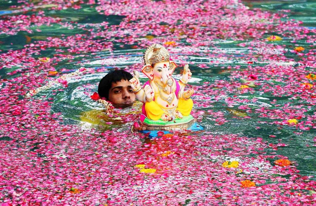 A devotee immerses an idol of the Lord Ganesh in Mumbai. (REUTERS/Shailesh Andrade)