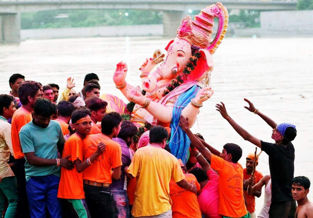 Devotees carry an idol of the Lord Ganesh, the deity of prosperity, into the Sabarmati river for its immersion during the ten-day-long Ganesh Chaturthi festival. (REUTERS/Amit Dave) 