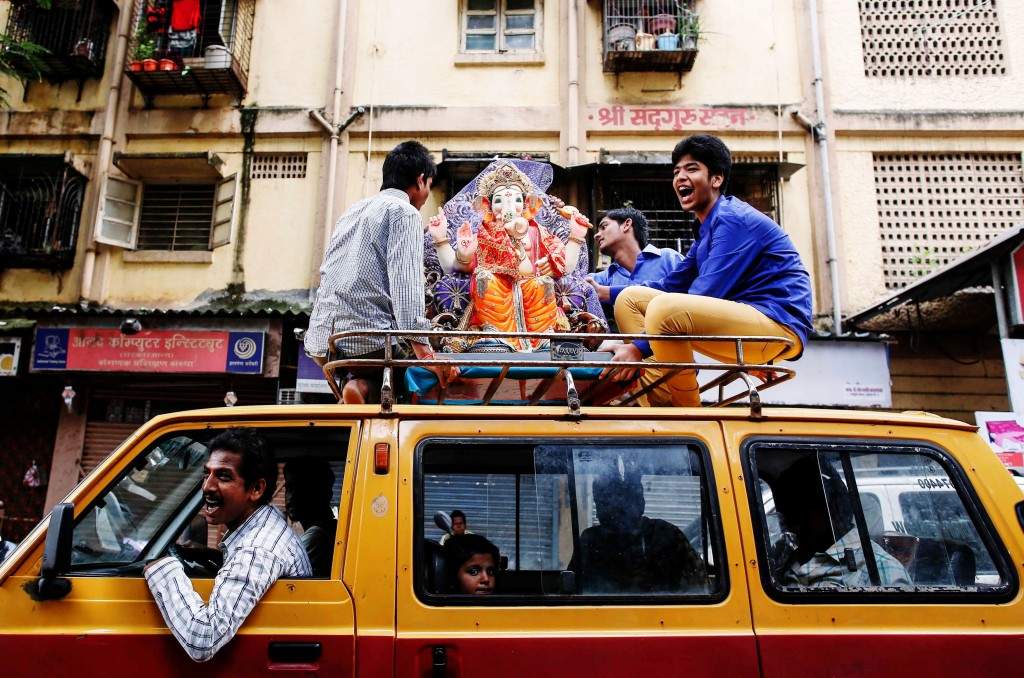 Devotees shout religious slogans as they carry a statue of the Hindu god Ganesh in Mumbai. (REUTERS/Danish Siddiqui)
