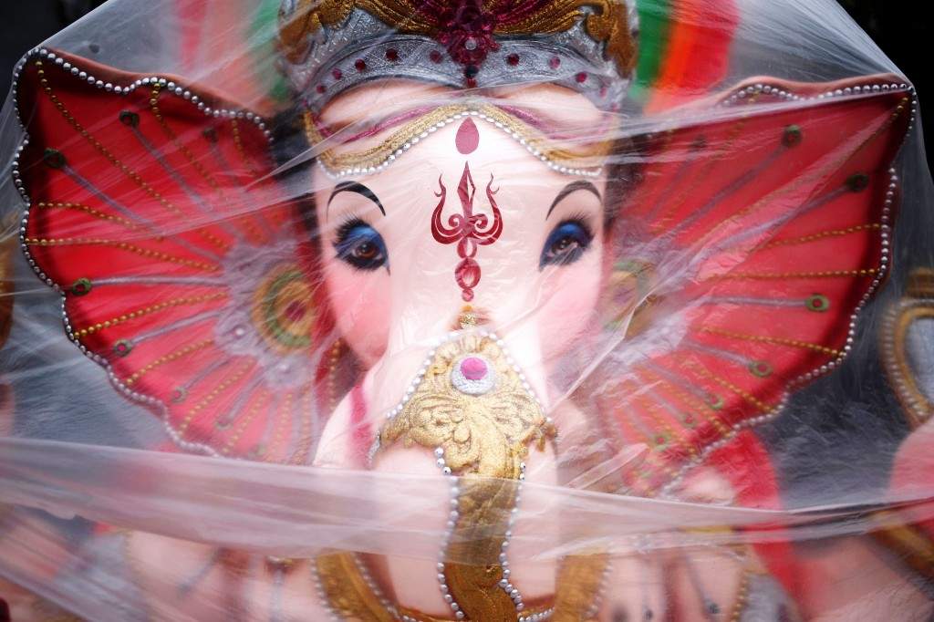 An idol of Lord Ganesh, the deity of prosperity, is covered in a plastic sheet before it is moved to a place of worship during the Ganesh Chaturthi festival in New Delhi. (REUTERS/Anindito Mukherjee) 