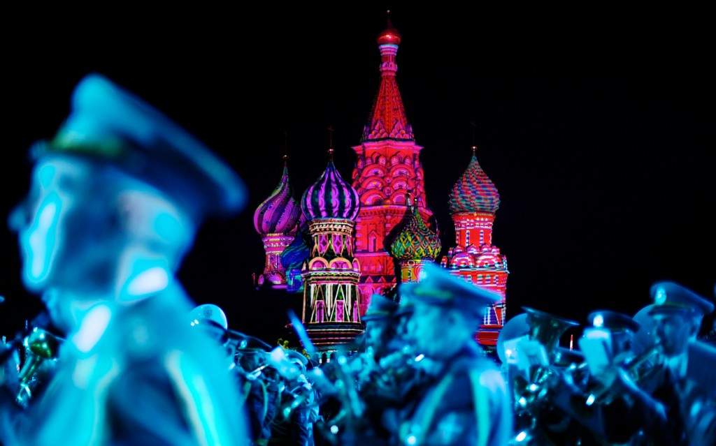 St. Basil Cathedral is lit using show lights as Serbian Nish military band members perform during the rehearsal of 'Spasskaya Tower' International Military Orchestra Music Festival at the Red Square in Moscow, Russia. (AP Photo/Ivan Sekretarev)