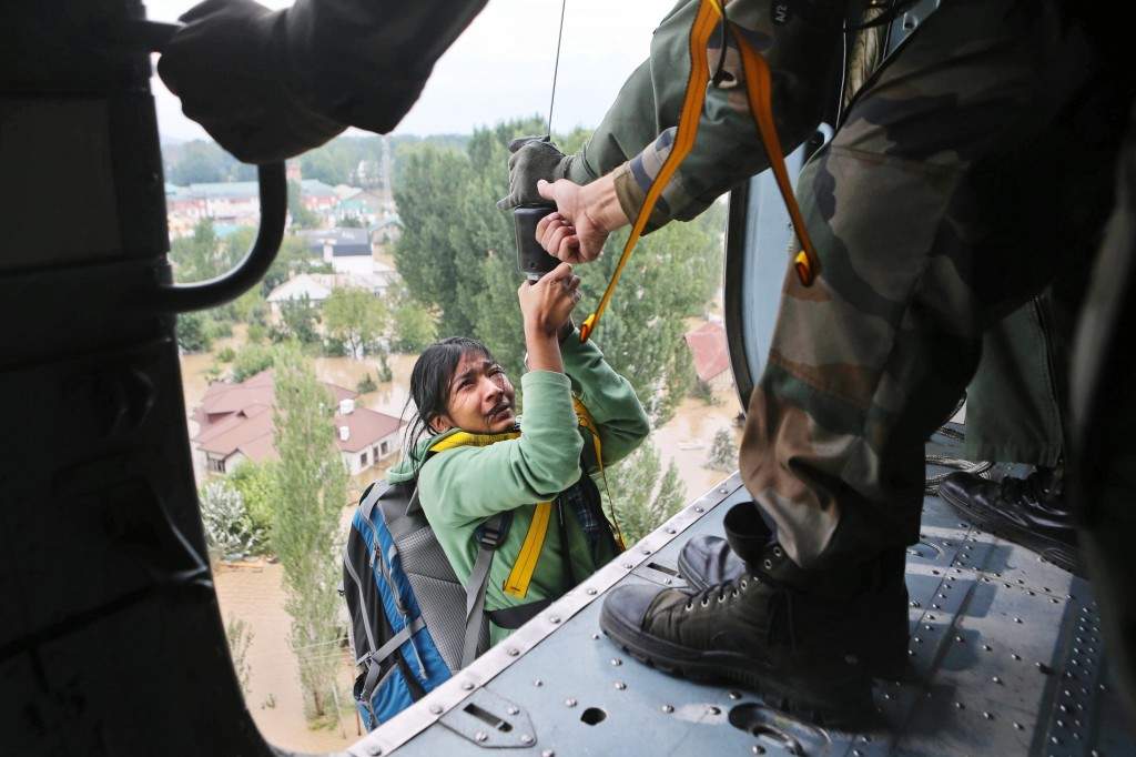 An tourist cries as she is airlifted into a chopper in Srinagar, India. (AP Photo/Dar Yasin)