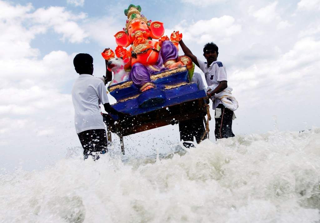 Fishermen carry an idol of the Lord Ganesh into the Bay of Bengal for its immersion. Ganesh idols are taken through the streets in a procession accompanied by dancing and singing, and later immersed in a river or the sea symbolising a ritual seeing-off of his journey towards his abode, taking away with him the misfortunes of all mankind. (REUTERS/Babu)