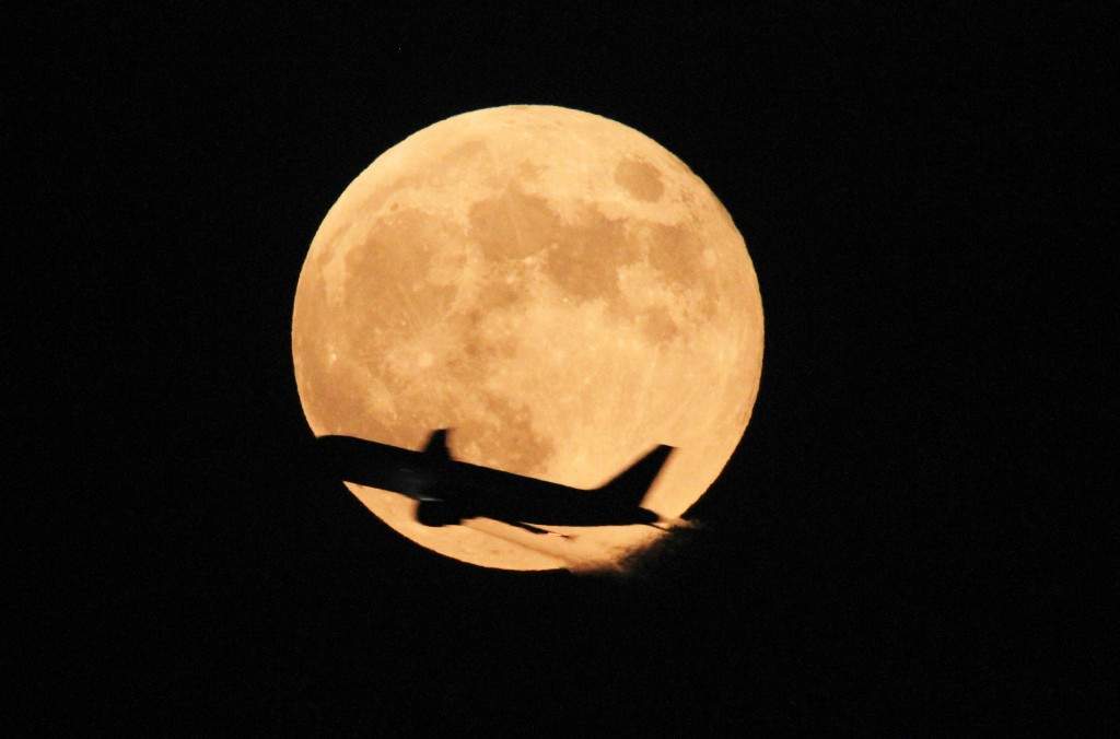 A passenger airliner crosses the full moon in Lahore, Pakistan. (AP Photo/K.M. Chaudary)