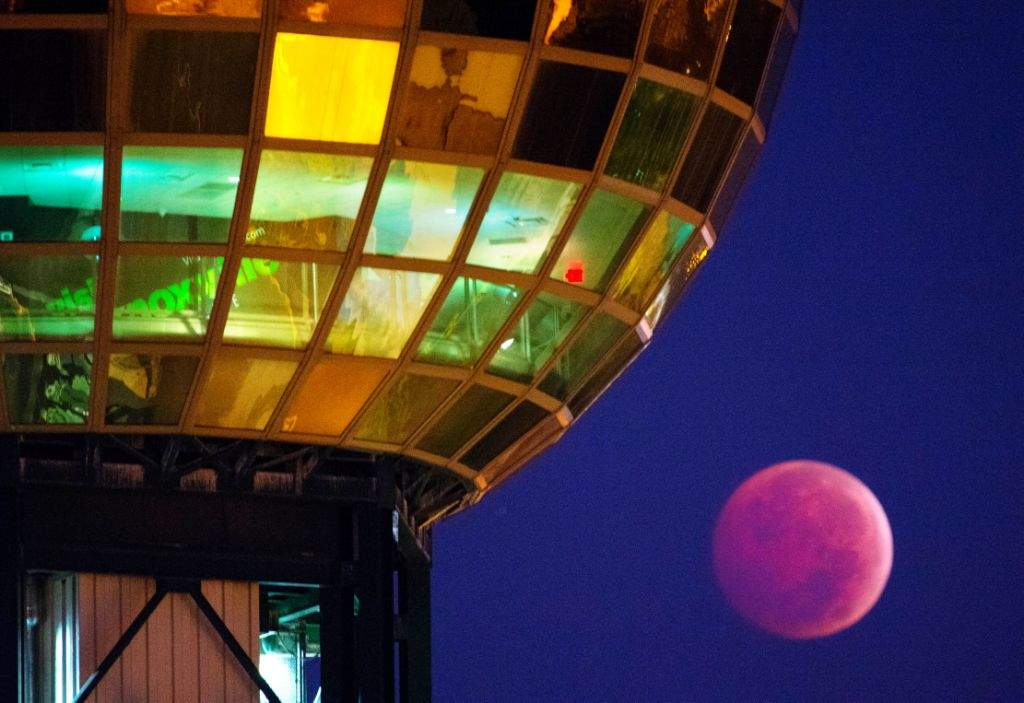 The Earth's shadow is cast over the moon during a total lunar eclipse, as seen from beneath the Sunsphere in Knoxville. (AP Photo/Knoxville News Sentinel, Adam Lau)