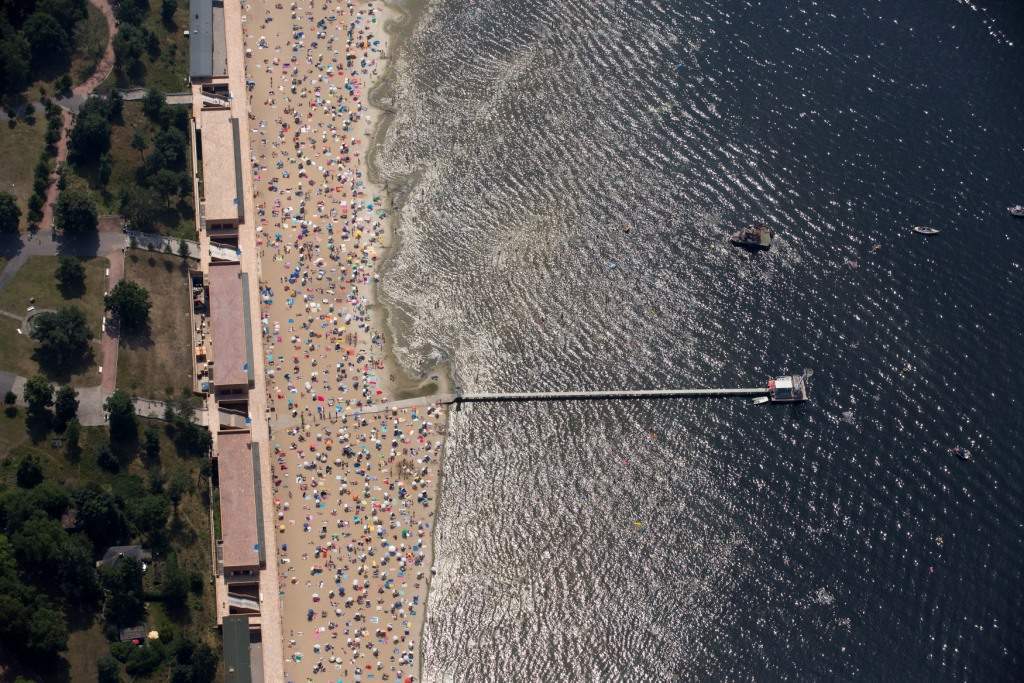People sunbathe and swim at the beach of Wannsee, near Berlin. (REUTERS/Axel Schmidt)