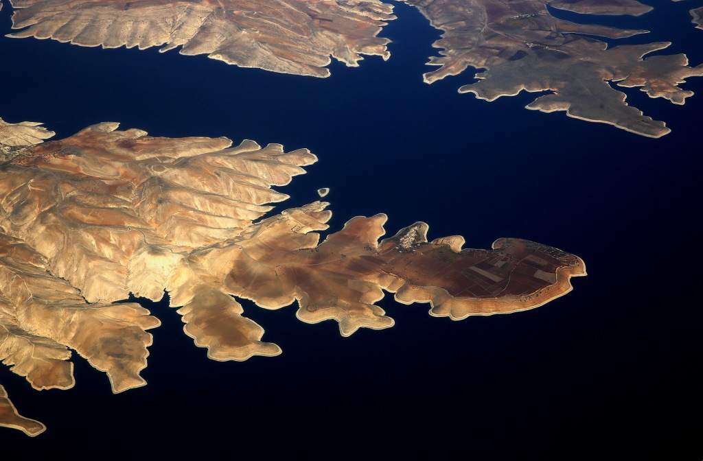 The town of Susuz is seen on the northern shore of the Ataturk dam through the window of a passenger aircraft flying over south-eastern Turkey province of Adiyaman. (REUTERS/Yannis Behrakis)