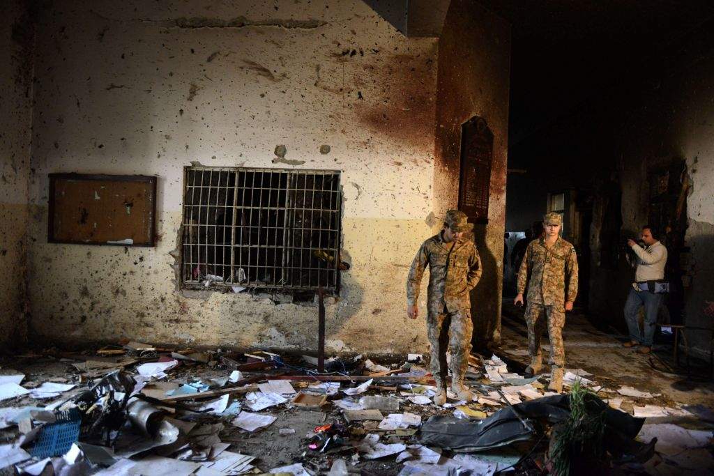 A Pakistani soldier walks amidst the debris in an army-run school a day after an attack by Taliban militants in Peshawar. (AFP PHOTO / A MAJEED)