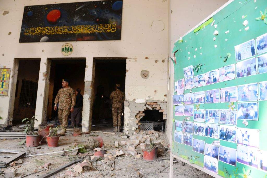 Pakistani soldiers walk amidst the debris in an army-run school a day after an attack by Taliban militants in Peshawar. (AFP PHOTO / A MAJEED)