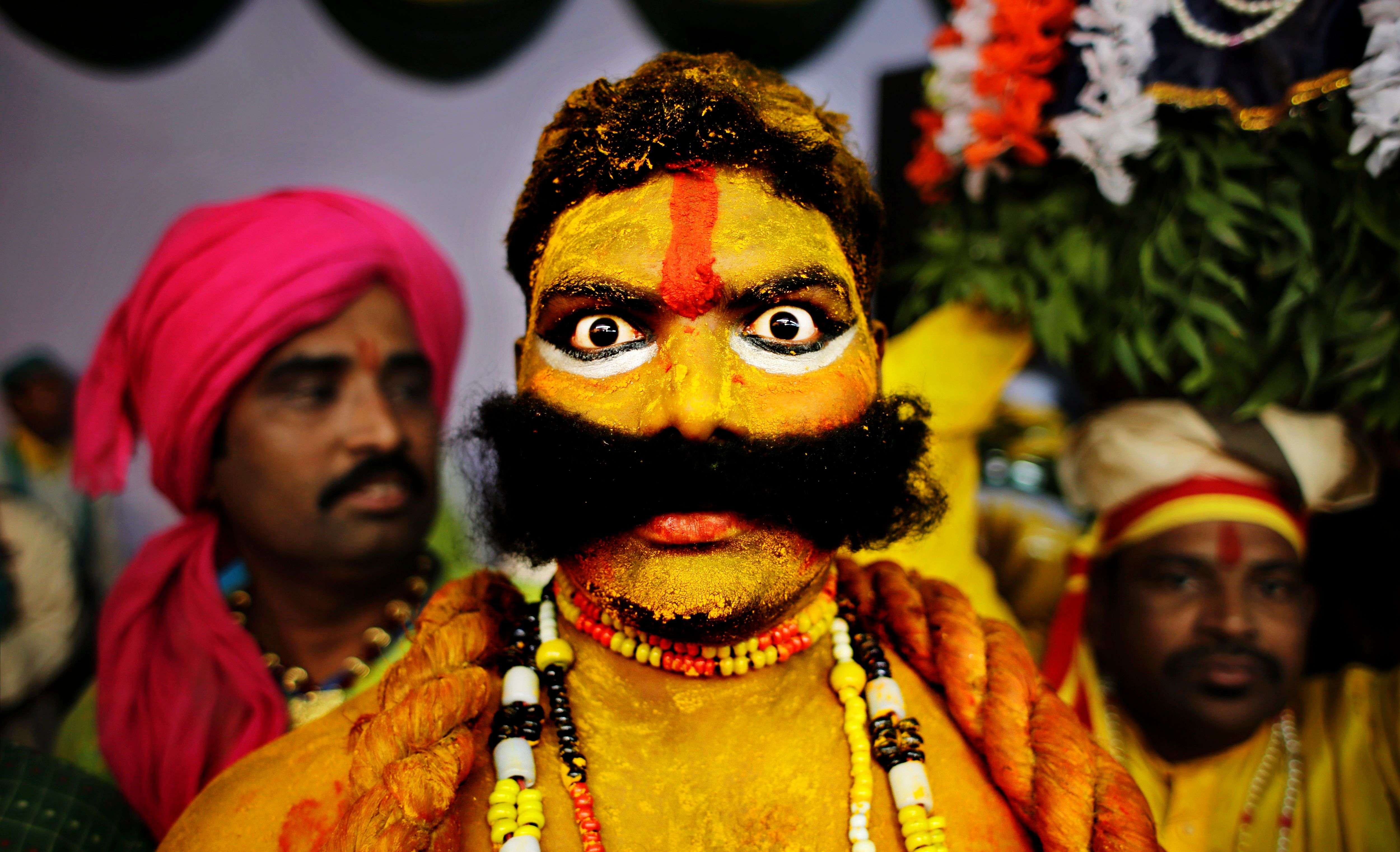 An artist from the state of Telangana reacts to the camera as they wait for their turn to perform during a media preview displaying a glimpse of culture of different parts of India, in New Delhi. (AP Photo/Altaf Qadri)