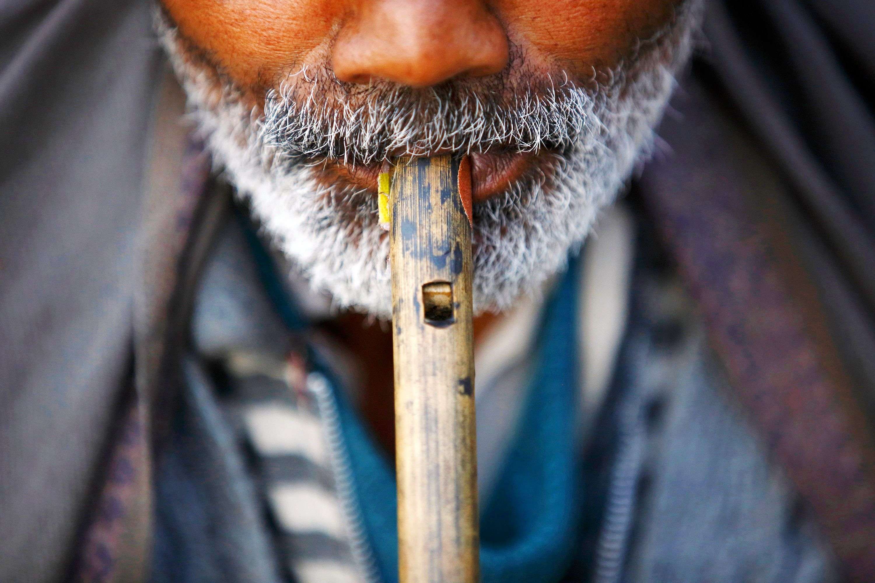 A sadhu plays a flute at the premises of Pashupatinath Temple in Kathmandu. (REUTERS/Navesh Chitrakar)