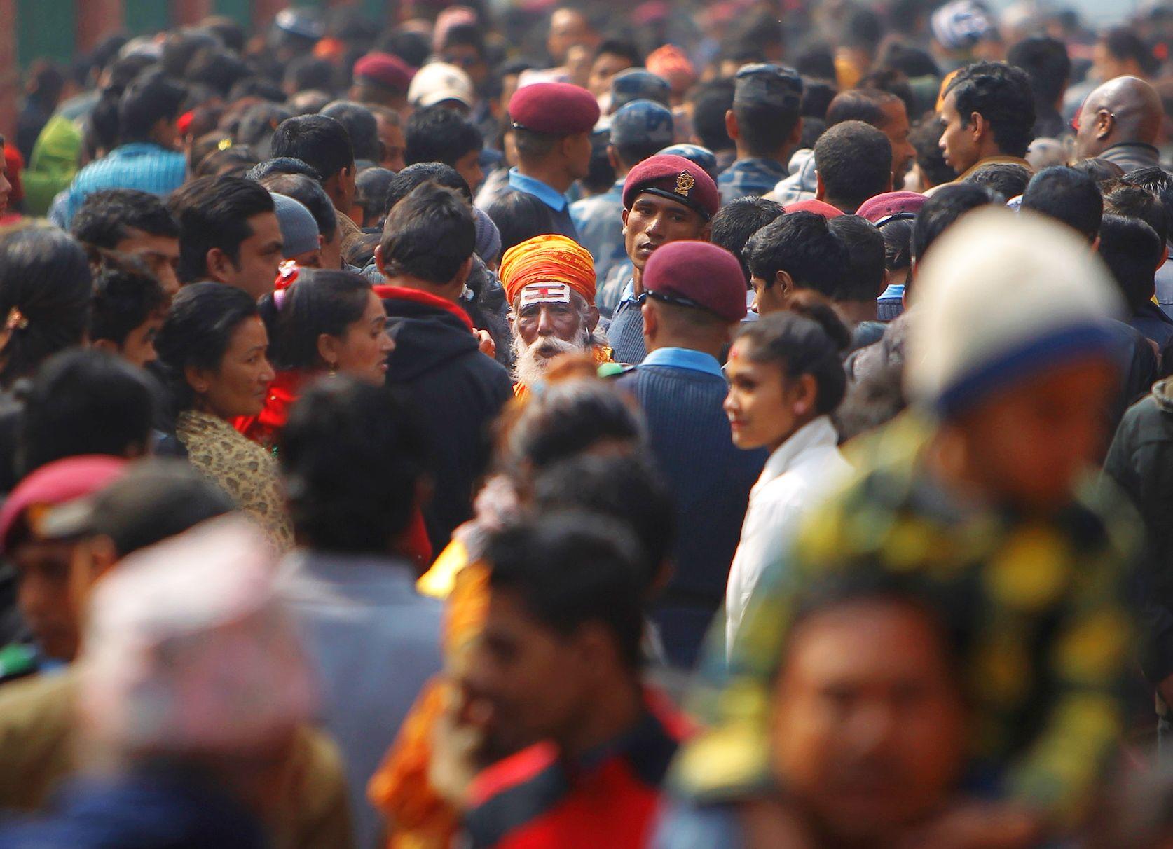 A holy man walks amid a sea of devotees at the Pashupatinath temple during Shivaratri festival in Kathmandu, Nepal. (AP Photo/Niranjan Shrestha)