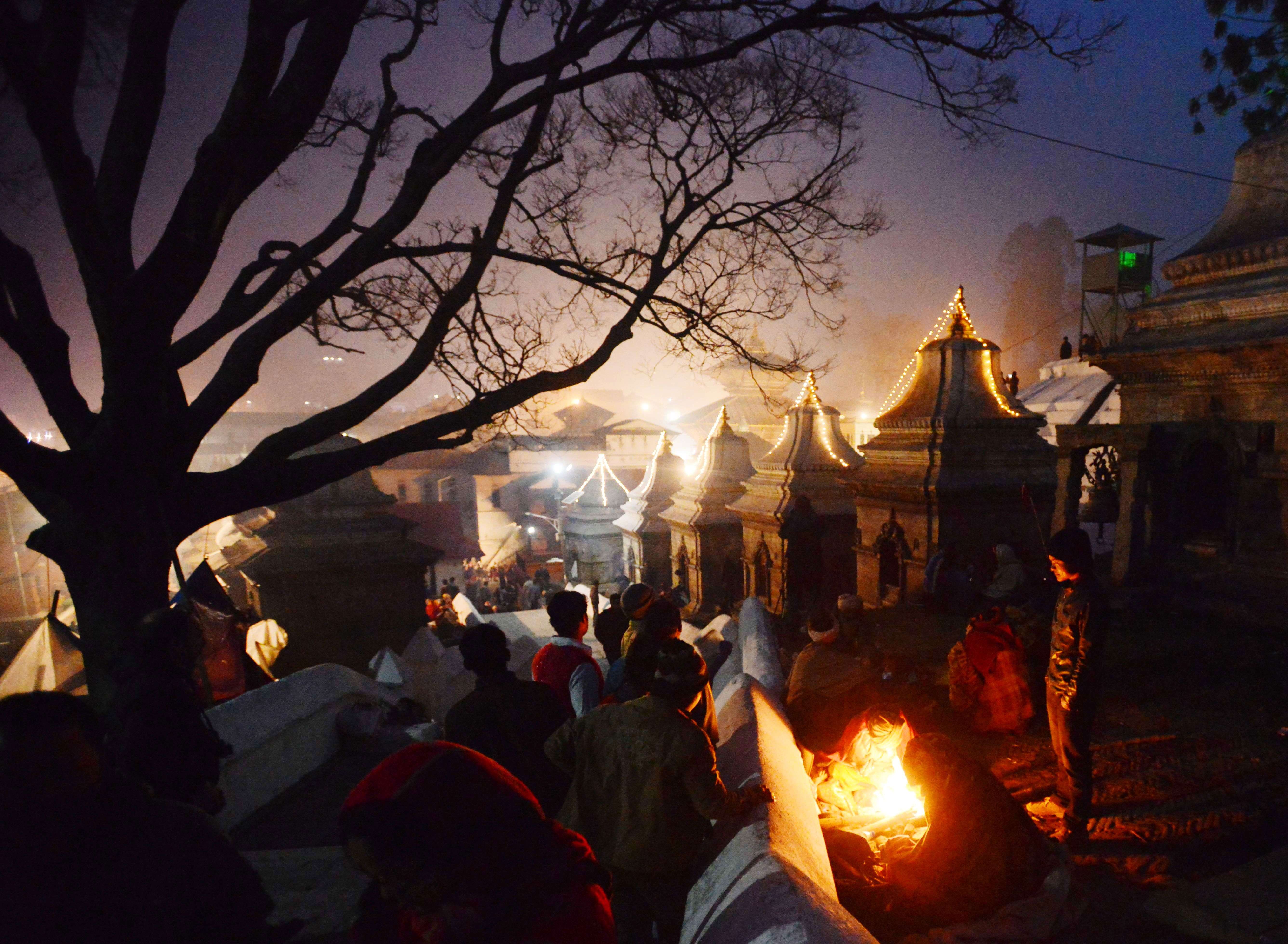 Worshippers warm themselves near a fire during the Maha Shivaratri festival in Kathmandu. (AFP PHOTO / PRAKASH MATHEMA)