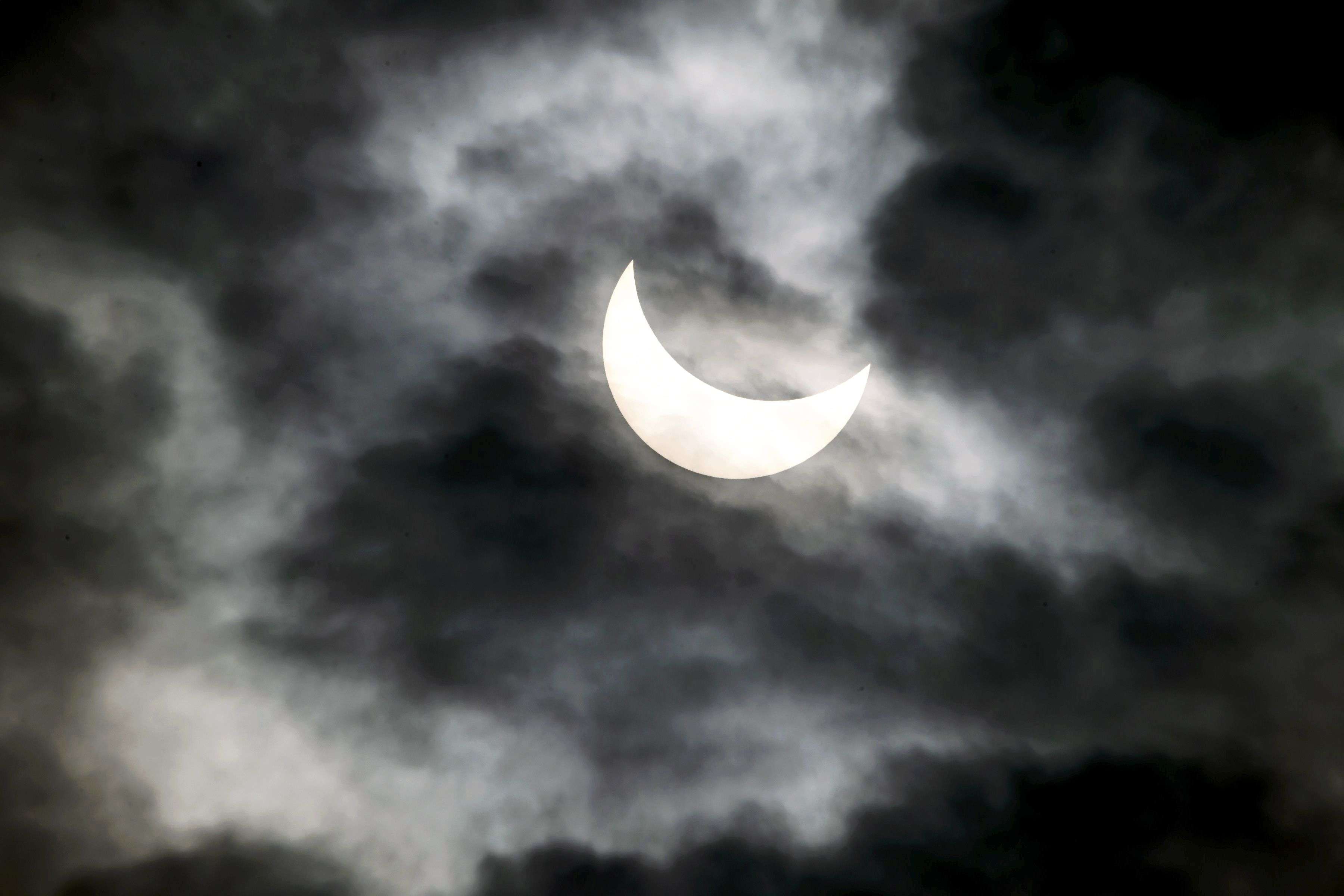 This picture shows a partial solar eclipse above Nyon, western Switzerland. (AFP PHOTO / FABRICE COFFRINI)