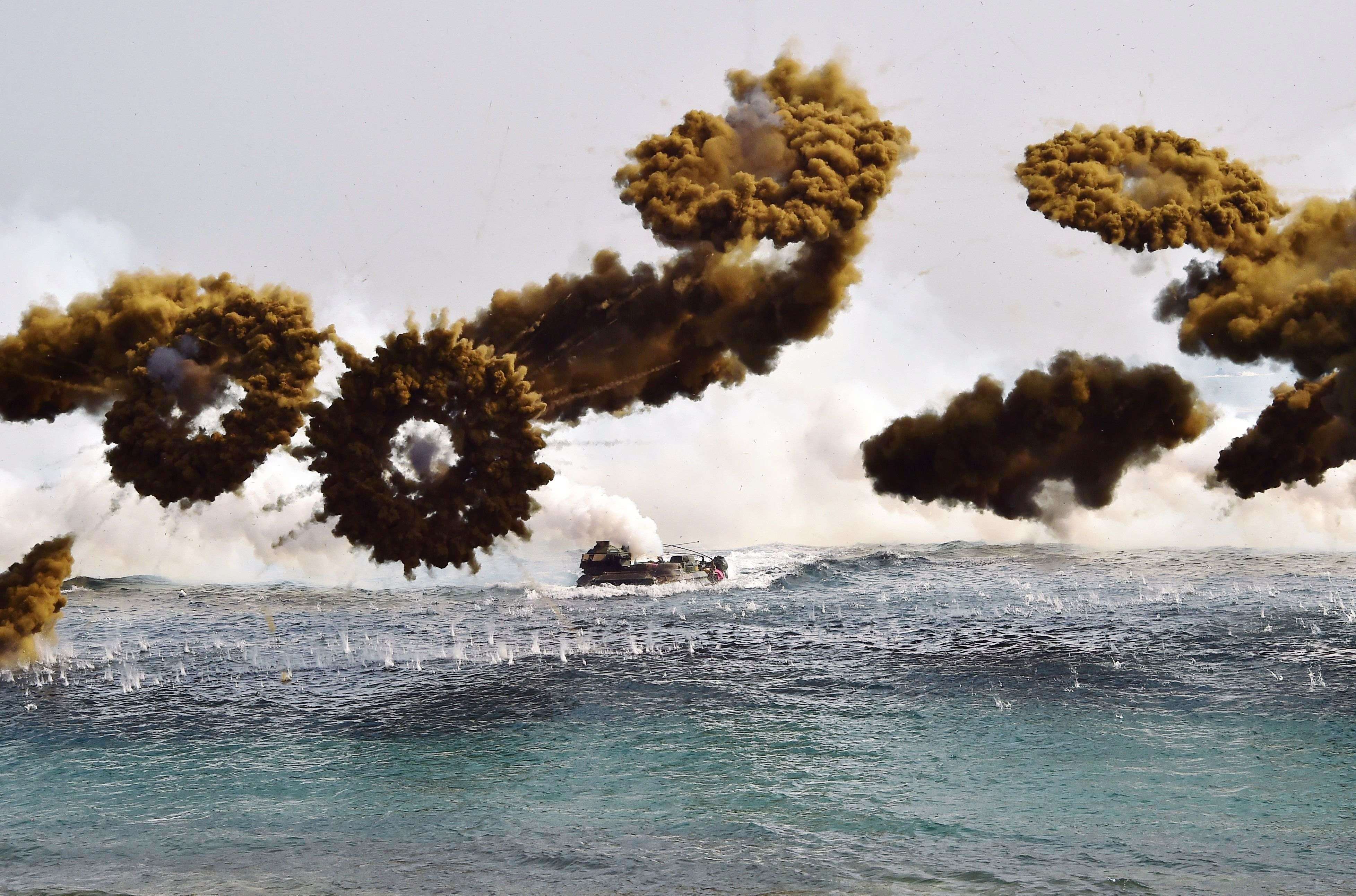 South Korean marine amphibious assault vehicles fire smoke shells to land on the seashore during a joint landing operation by US and South Korean Marines in the southeastern port of Pohang. (AFP photo / Jung Yeon-Je)