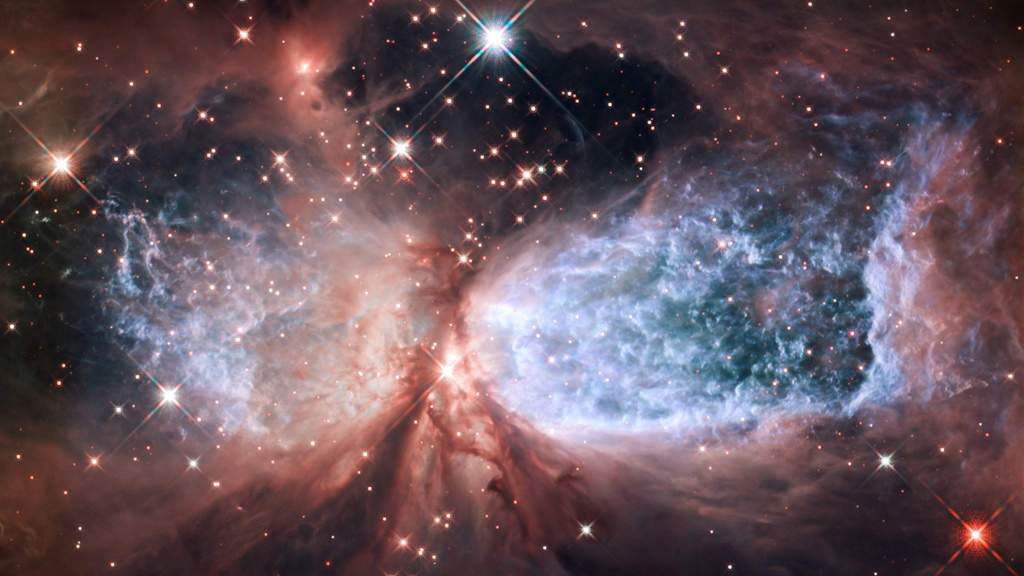S106: A massive, young star is responsible for the furious activity we see in the nebula Sharpless 2-106, or S106 for short. Twin lobes of super-hot gas, glowing blue in this image, stretch outward from the central star. This hot gas creates the "wings" seen here. A ring of dust and gas orbiting the star acts like a belt, cinching the expanding nebula into an "hourglass" shape. (Courtesy: http://hubblesite.org/)