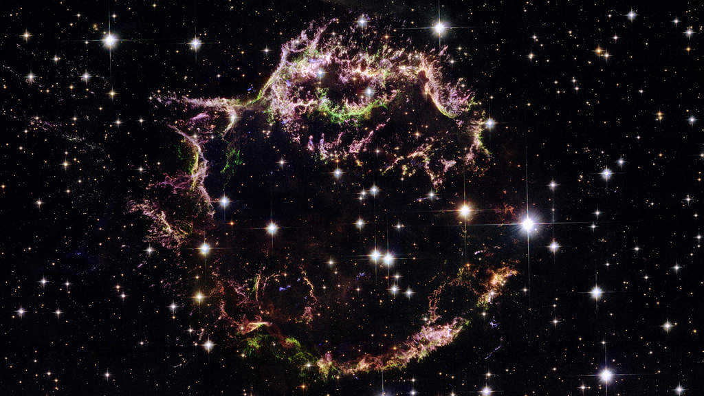 Supernova Remnant Cassiopeia A: A supernova such as the one that resulted in supernova remnant Cassiopeia A (Cas A) is the explosive demise of a massive star that collapses under the weight of its own gravity. The collapsed star then blows its outer layers into space in an explosion that can briefly outshine its entire parent galaxy. Cas A is relatively young, estimated to be only about 340 years old. Hubble has observed it on several occasions to look for changes in the rapidly expanding filaments.  (Courtesy: http://hubblesite.org/)