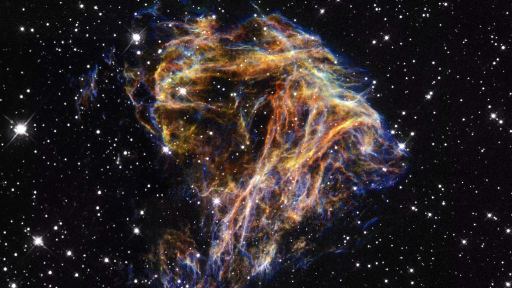 DEM L 190: Resembling the puffs of smoke and sparks from a summer fireworks display, these delicate filaments are actually sheets of debris from a stellar explosion in a neighboring galaxy. Denoted N 49, or DEM L 190, this is the remnant of a massive star that died in a supernova blast whose light would have reached Earth thousands of years ago.  (Courtesy: http://hubblesite.org/)