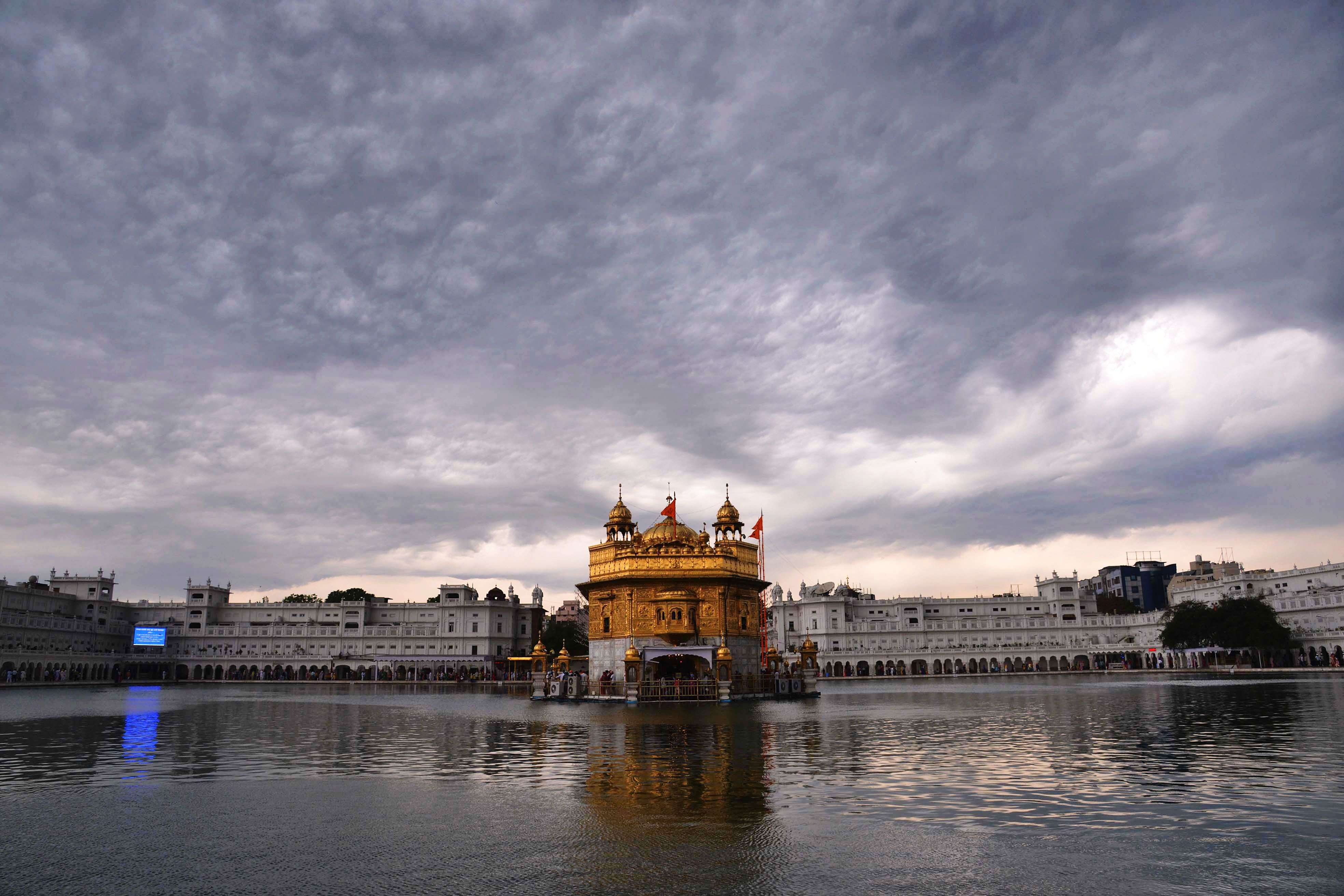 Dark clouds loom over the holiest Sikh shrine, the Golden temple in Amritsar. (AFP PHOTO/NARINDER NANU)