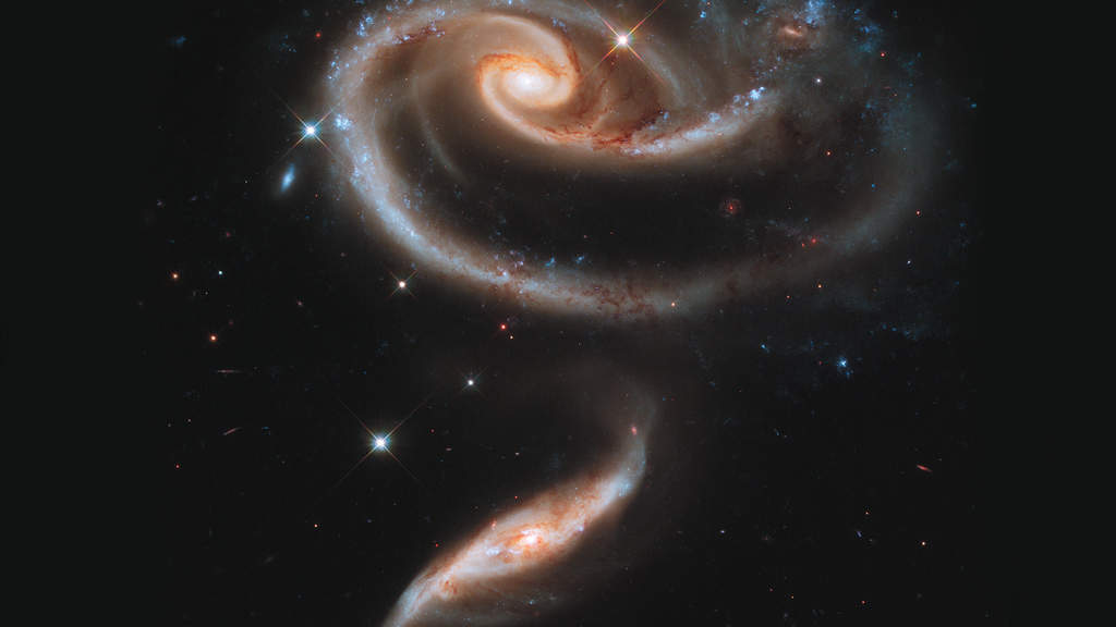 Arp 273: Galaxies collide! The titanic gravitational forces rip apart entire galaxies and they fall back together, forming completely different structures. Interacting galaxies provide some of the most interesting and varied visual forms known. Arp 273 is a particularly interesting example of this, with terrific form, a strong feeling of motion and power, yet extraordinarily graceful. (Courtesy: http://hubblesite.org/)