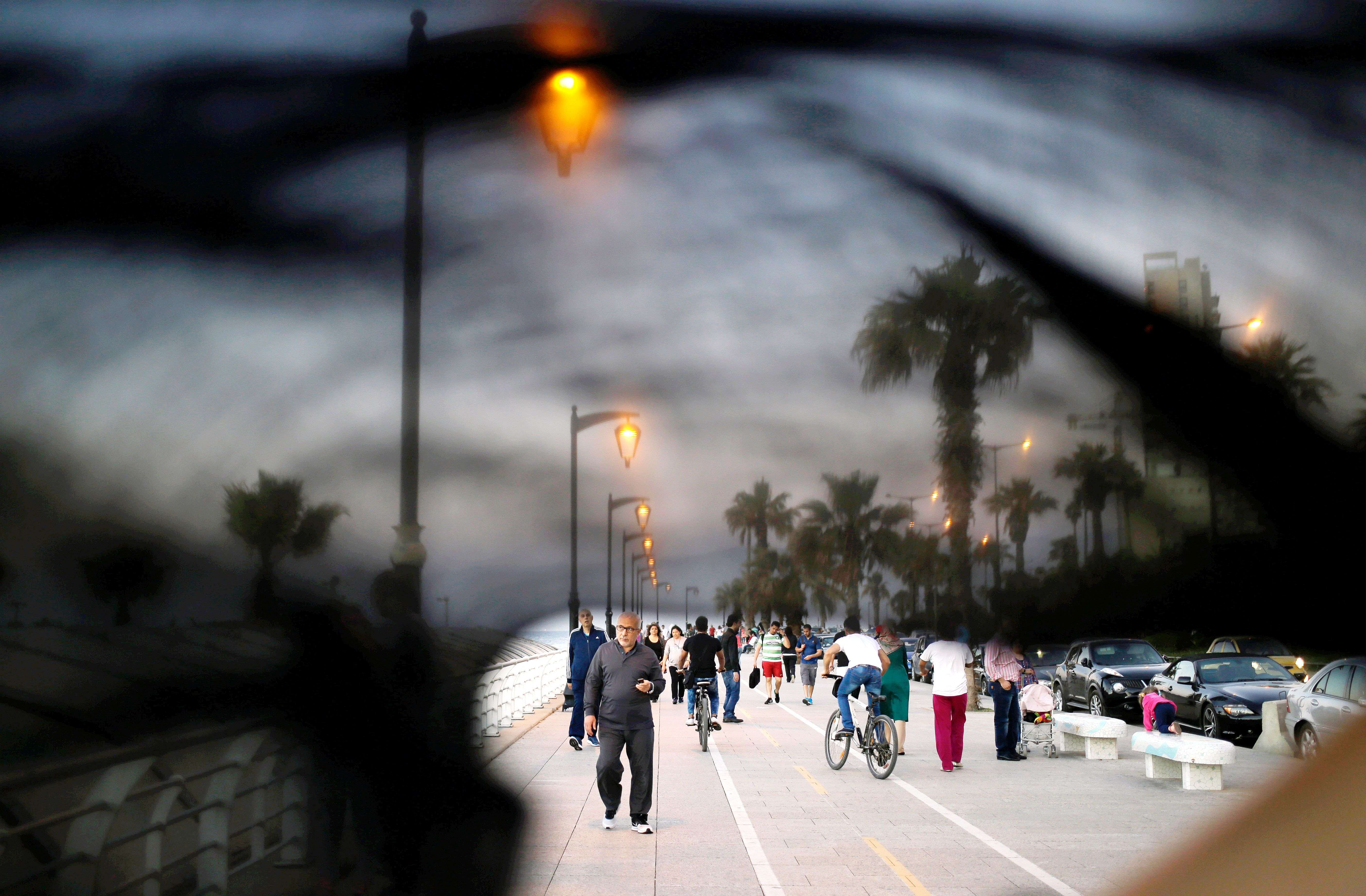 Lebanese citizens walking on the Corniche, or waterfront promenade in Beirut, Lebanon.