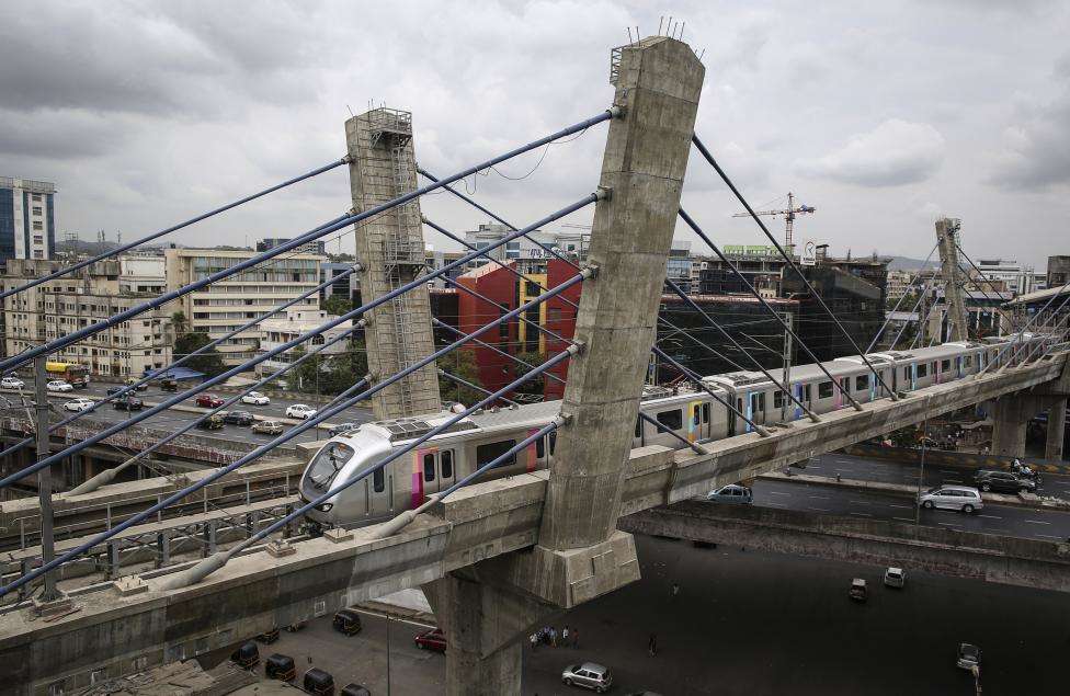 A metro train travels over a flyover at a residential area in Mumbai. (REUTERS/Danish Siddiqui/Files)