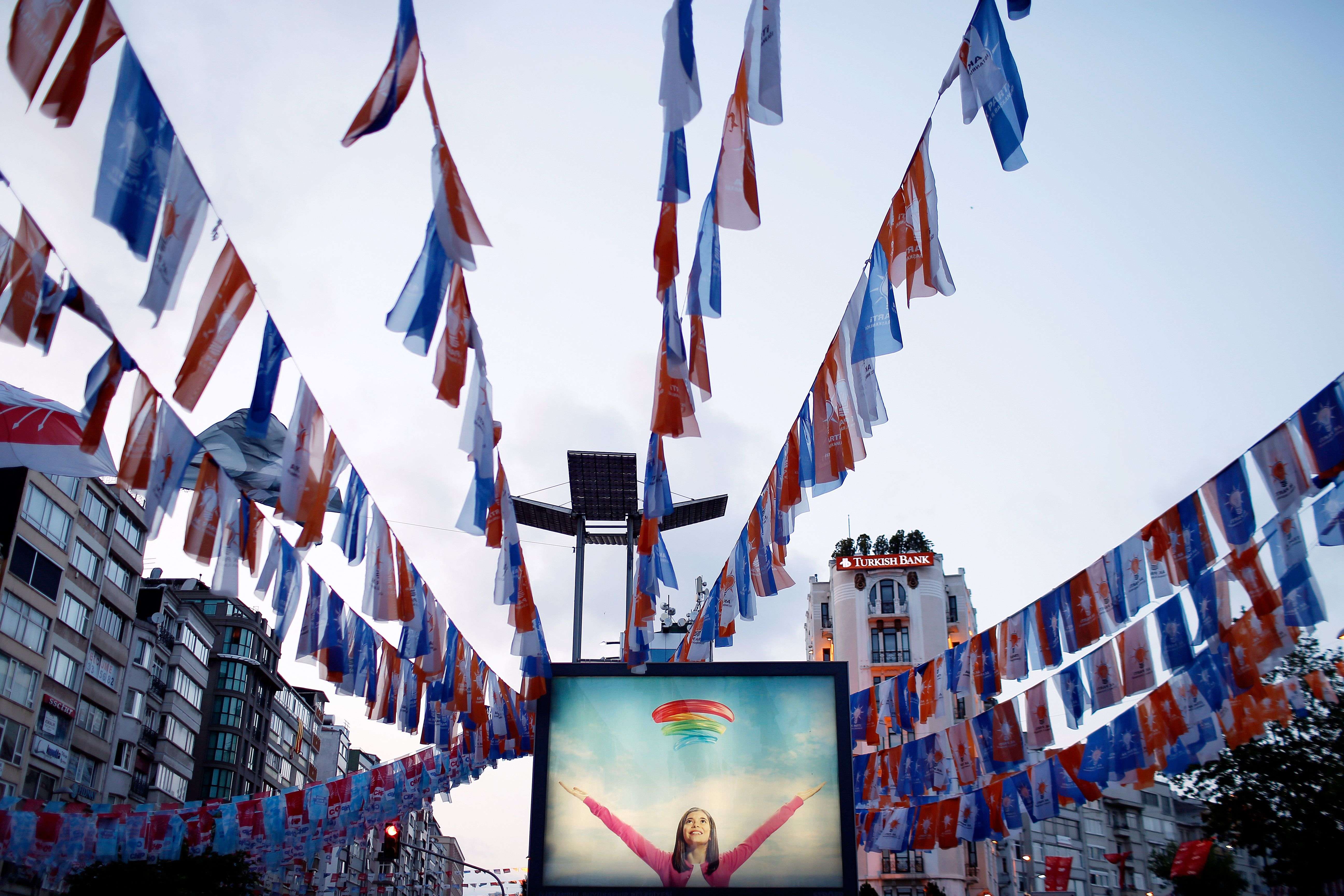 Turkey’s governing Justice and Development Party, (AKP) flags are seen over an advertising billboard in Istanbul, Turkey. (AP/Emrah Gurel) 