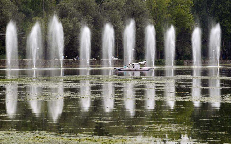 A Kashmiri man rows a boat past fountains in the polluted waters of Dal Lake, in Srinagar. The lake has been polluted during decades of neglect and a separatist revolt. Dal Lake, the region's main tourist attraction which has drawn visitors from Mughal emperors to the Beatles star George Harrison, has shrunk from 25 sq km to 13 sq km since the 1980s, environmental campaigners say. (REUTERS/Fayaz Kabli/Files)