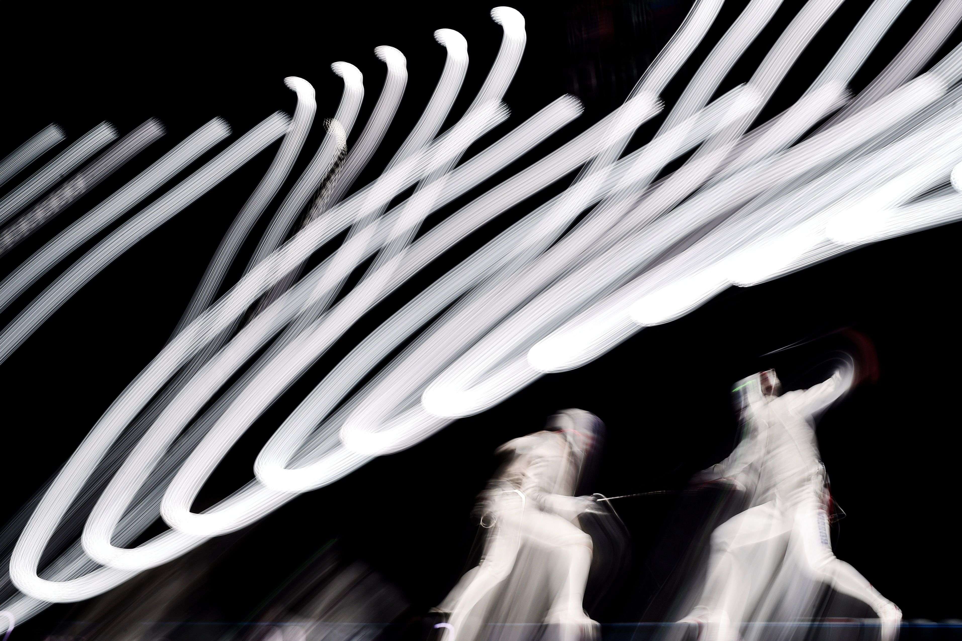 A long long exposure picture shows Japan's Yuki Ota (L) vying with US Alexander Massialas during the men's foil final event at the 2015 World Fencing Championships in Moscow. (AFP/ Kirill Kudryavtsev) 